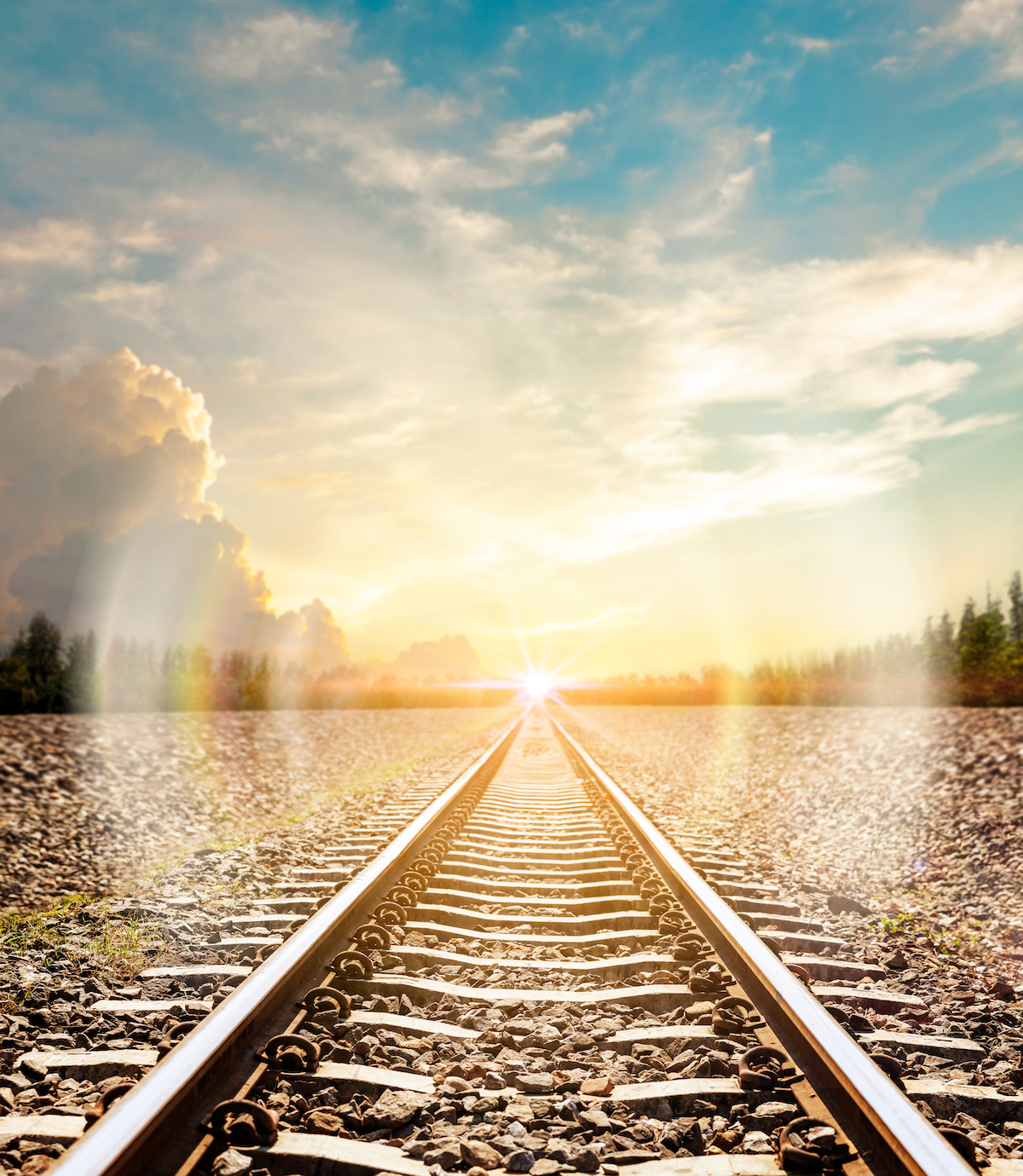 The longest railroad tracks with lens flare lighting.